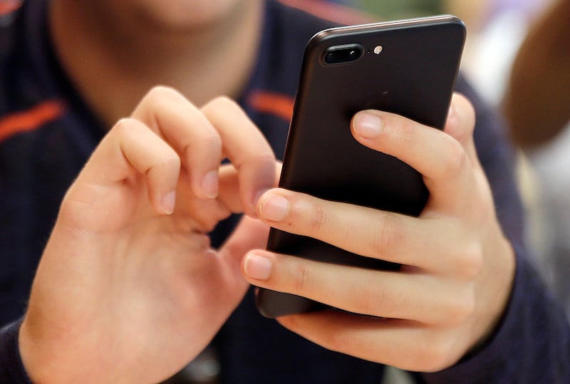 In this Friday, Sept. 16, 2017, file photo, a person uses a smartphone in Chicago.