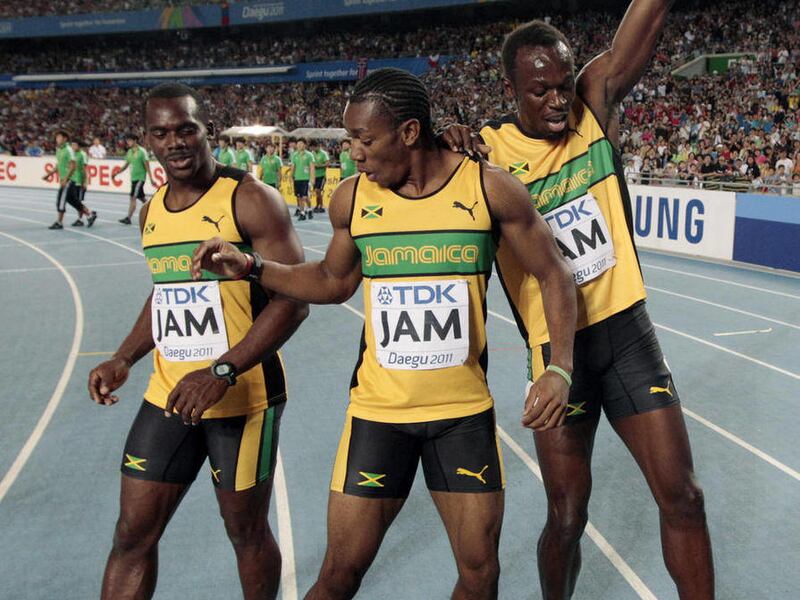 Jamaica's Usain Bolt, right, Yohan Blake, center, and Nesta Carter dance after winning the gold in the Men's 4x100m relay final at the World Athletics Championships in Daegu, South Korea, Sunday, Sept. 4, 2011.