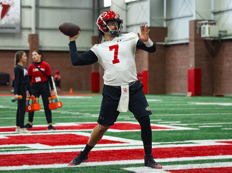 Utah quarterback Cam Rising throws
