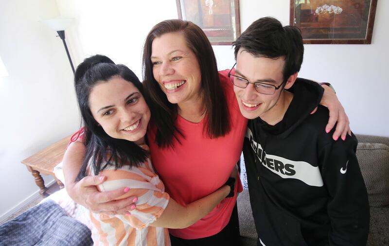 Lori Lloyd hugs two of her children, Taisia Encinias and Tanner Lloyd, at her home in Midvale, Utah, on Saturday, June 15, 2019. Lloyd is a mother of three and a former meth addict who was incarcerated from 2007-2009.