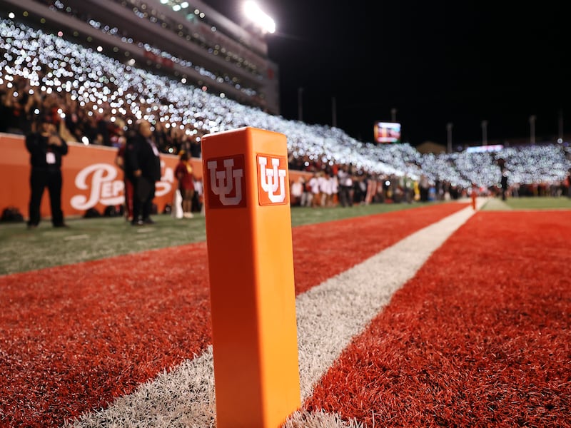 Fans stand and shine their lights in honor of former players Ty Jordan and Aaron Lowe at Rice-Eccles Stadium.