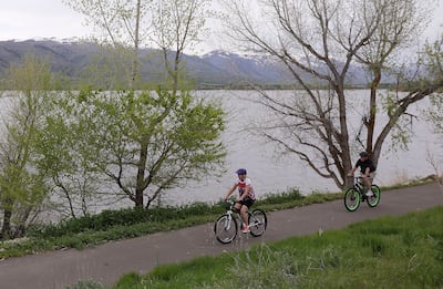 Debbie St. James and Mike St. James bike on a bike path along the Pineview Reservoir near Huntsville, Weber County, on Wednesday, May 15, 2019.