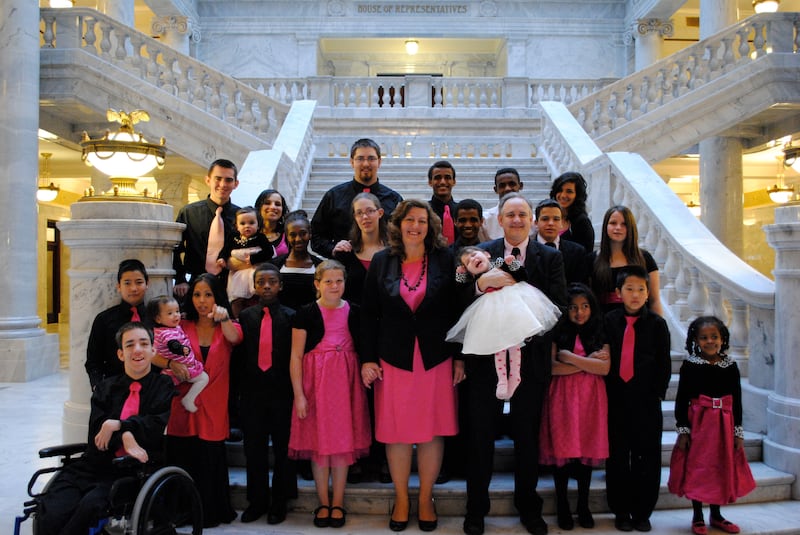 Large family in coordinating pink and black outfits inside Utah’s Capitol building