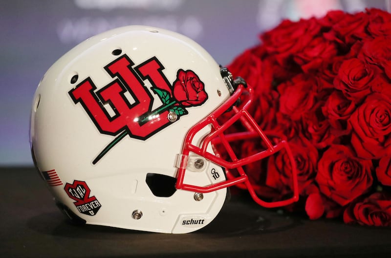A white Utah Utes helmet is displayed