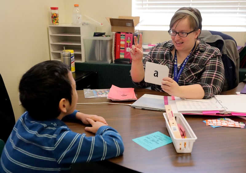 Kari Olsen, first-grade teacher, does one-on-one tutoring with Mason Goodwin at Noah Webster Academy in Orem on Friday, Feb. 15, 2019. Some states are proposing that the Bible be taught in public schools — not for moral education, but for its literary and