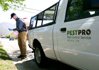 Casey Haight, of PestPro, prepares to spray a home for spiders and ants in Salt Lake City on Thursday, May 2, 2019.