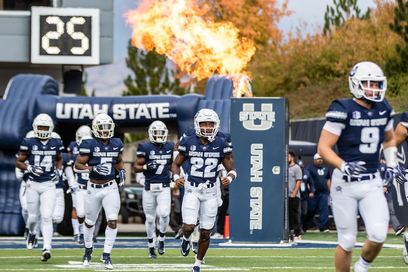 FILE: Utah State senior running back Eltoro Allen (22) runs onto the field prior to the Aggies' game against UNLV earlier this season at Maverik Stadium in Logan, Utah.