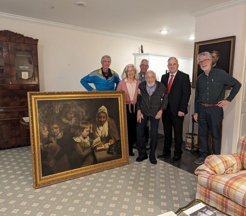 Special Agent Gary France (second right), Dr. Francis Wood and Wood’s children stand next to the John Opie painting that was stolen from Wood’s parents’ home in 1969. 