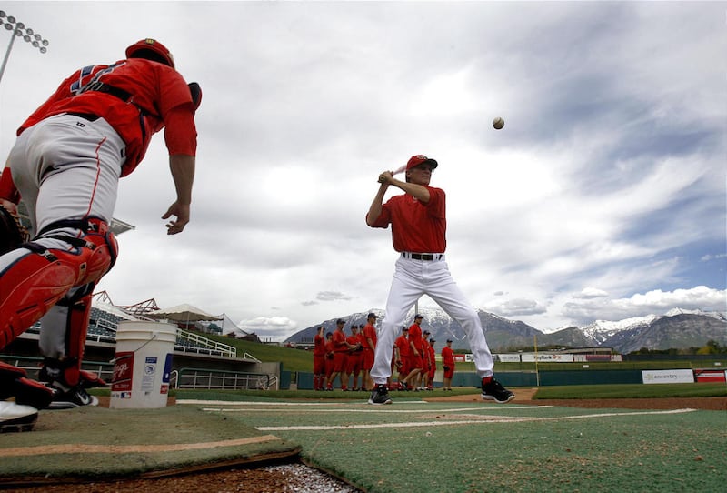 Owlz' manager Tom Kotchman hits grounders to his team during practice at Utah Valley University. Orem and Ogden open the season tonight.