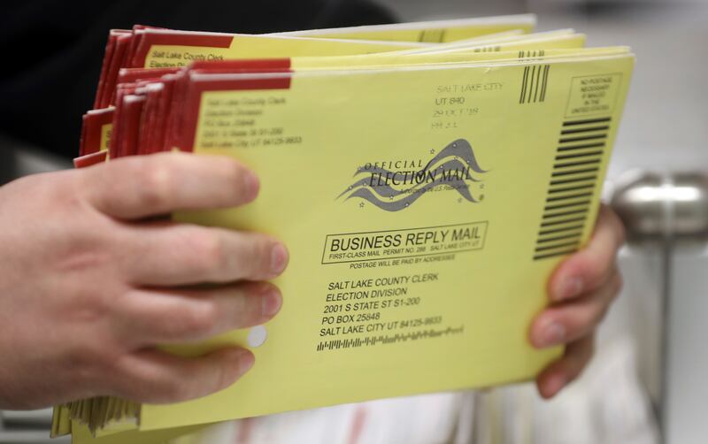 In this Wednesday, Oct. 31, 2018, photo, election workers process returned voted ballots in the Salt Lake County Government Center, in Salt Lake City.