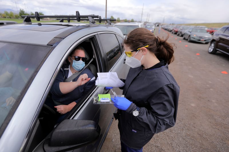 Sarah Fausett, a registered nurse and advanced EMT with RapidScreen Solutions LLC, tests Jennifer Stradling, left, for COVID-19 antibodies at Galena Hills Park in Draper on Wednesday, May 20, 2020.