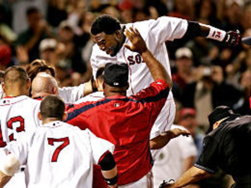 Boston's David Ortiz leaps onto home plate after hitting a walk-off home run to beat the Angels.