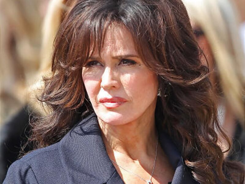 Marie Osmond watches as the casket of her son, Michael Bryan, 18, is taken from church.
