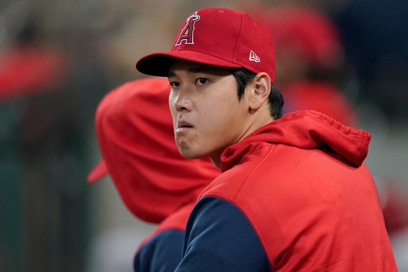 Los Angeles Angels’ Shohei Ohtani looks out from the dugout during the sixth inning of a baseball game against the Seattle Mariners, Friday, June 17, 2022.