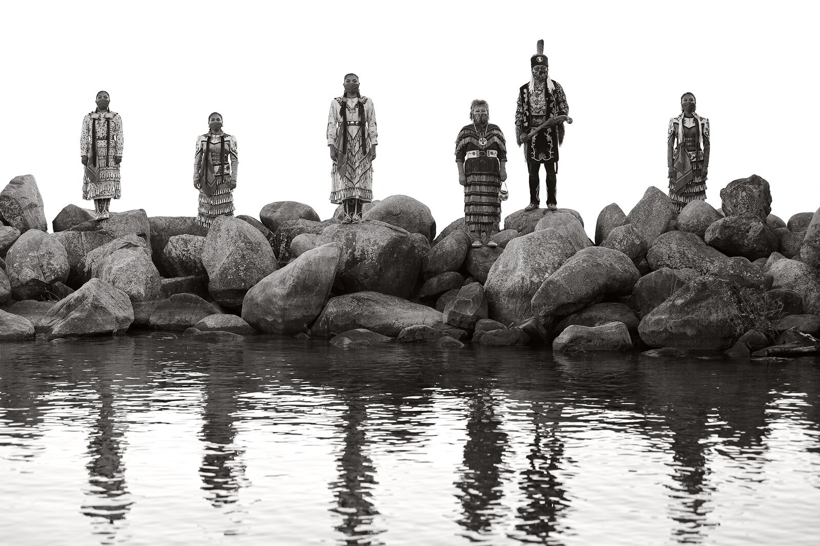 Native dancers stand on rocks at the Old Agency Village in Leech Lake Reservation in Minnesota.