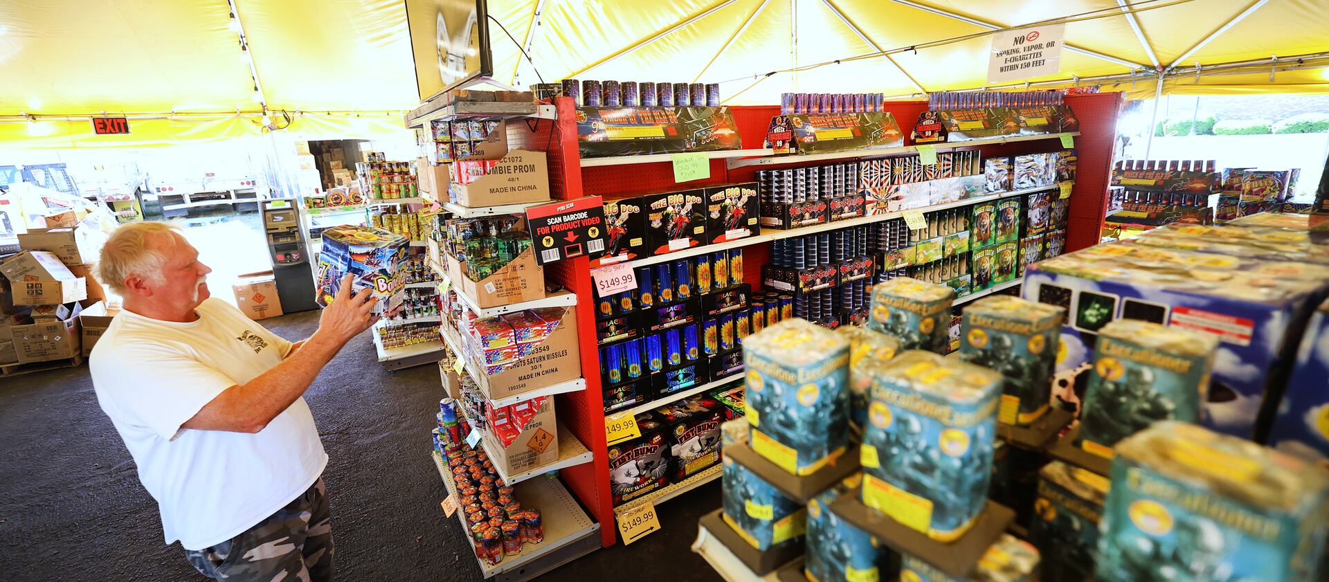 George Jensen uses a product scanner to see what different items will look like at Mad Matt’s Fireworks in Sandy.
