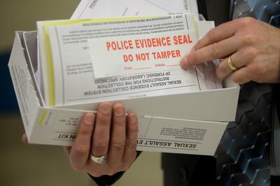 FILE - This Feb. 8, 2017, photo, Utah State Crime Lab Director Jay Henry holds a sexual assault evidence collection kit following a committee meeting at the Utah State Capitol, in Salt Lake City.