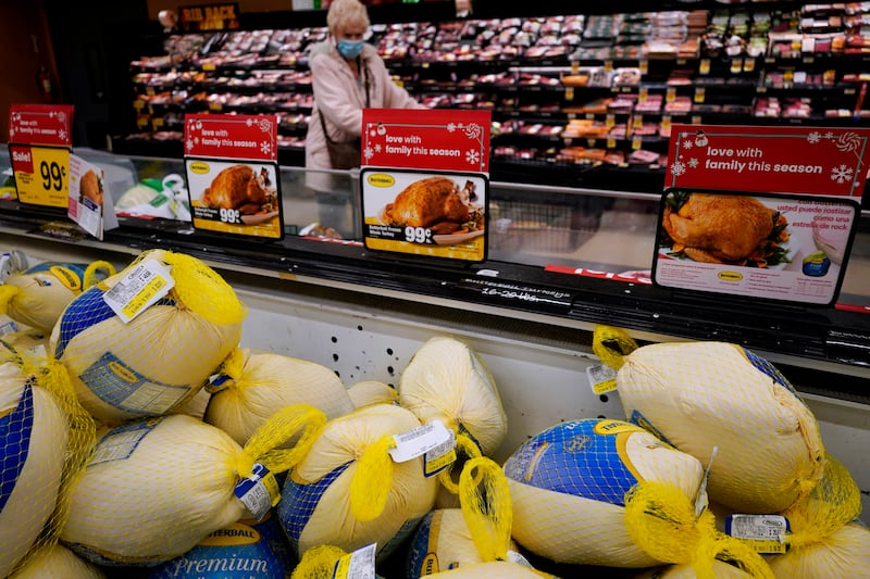 Frozen turkeys sit in a refrigerated case inside a grocery store in Mount Prospect, Ill.
