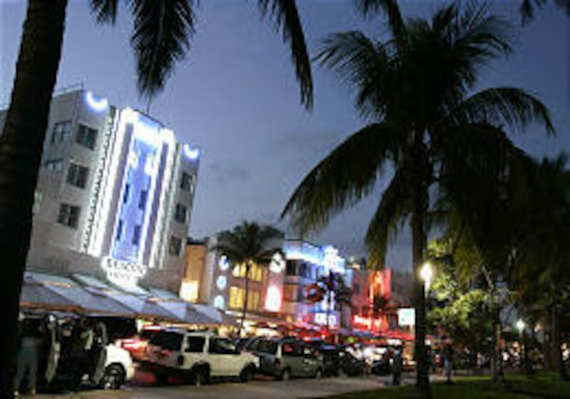 Art deco design hotels are bathed in neon light on Ocean Drive in Miami Beach, Fla. Those who descend on Miami for the Super Bowl in February will be greeted by the sandy coastline and pulsating clubs that have long been synonymous with this tropical play