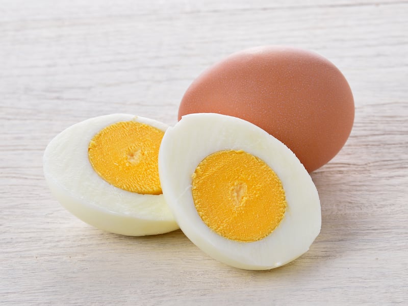 A sliced boiled egg sits on a table.