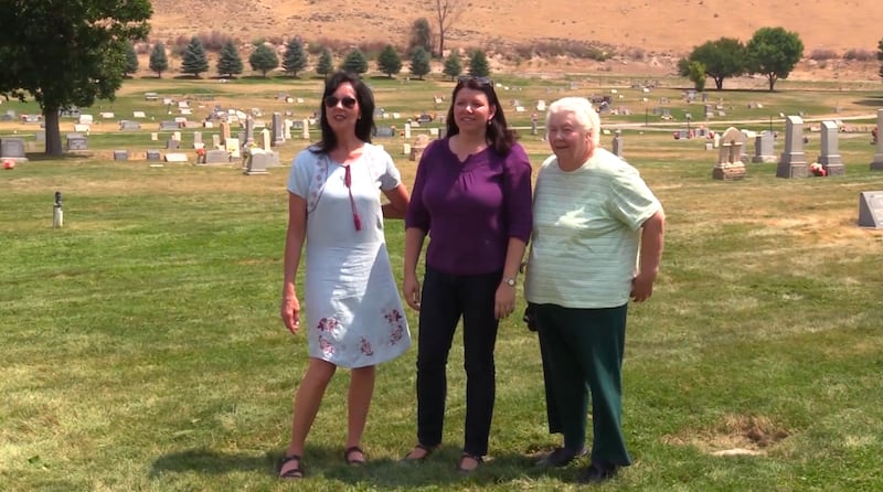 Alice Christenson, Deenna Price and Price's mother, Linda Chappell, stand near the grave of Deeanna Price's great-great-grandfather in the Pioneer Cemetery in Salina, Sevier County. The headstone was found under 5 inches of sod and dirt.