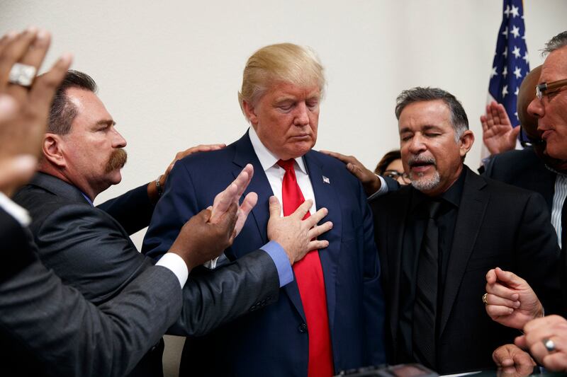 Pastors from the Las Vegas area pray with Republican presidential candidate Donald Trump during a visit to the International Church of Las Vegas and International Christian Academy, Wednesday, Oct. 5, 2016, in Las Vegas.