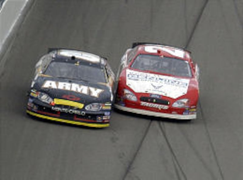 Joe Nemechek, left, and Ricky Rudd nearly touch with a lap to go.