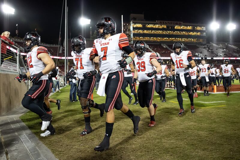 Utah Utes quarterback Cameron Rising and teammates finish warmups before the game against the Stanford Cardinal.