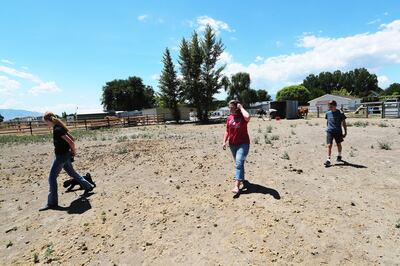 Shani Barker, daughter Rachel and son Billy walk in their horse coral as they talk about a proposed high-density development project near their home in Erda on Friday, July 13, 2018.
