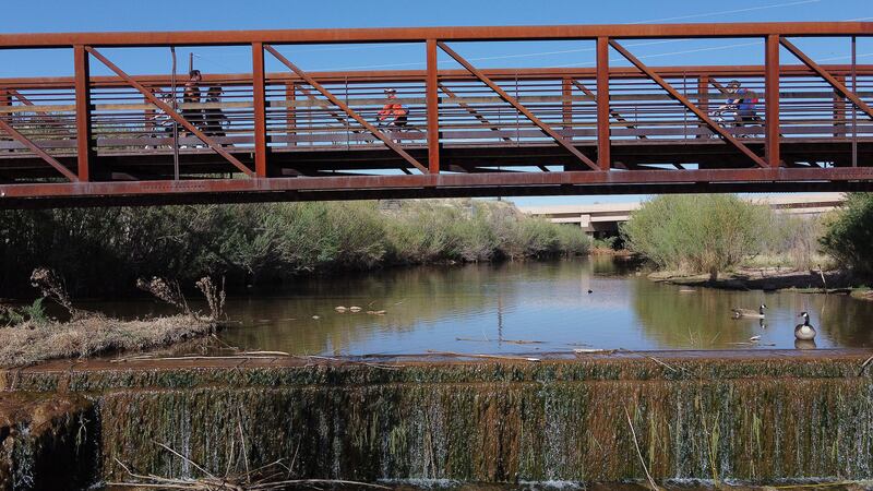 Pedestrians and bikers cross a bridge on the Virgin River Trail in St. George on April 9, 2021.