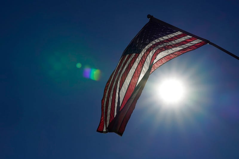 An American flag flies from a light pole.