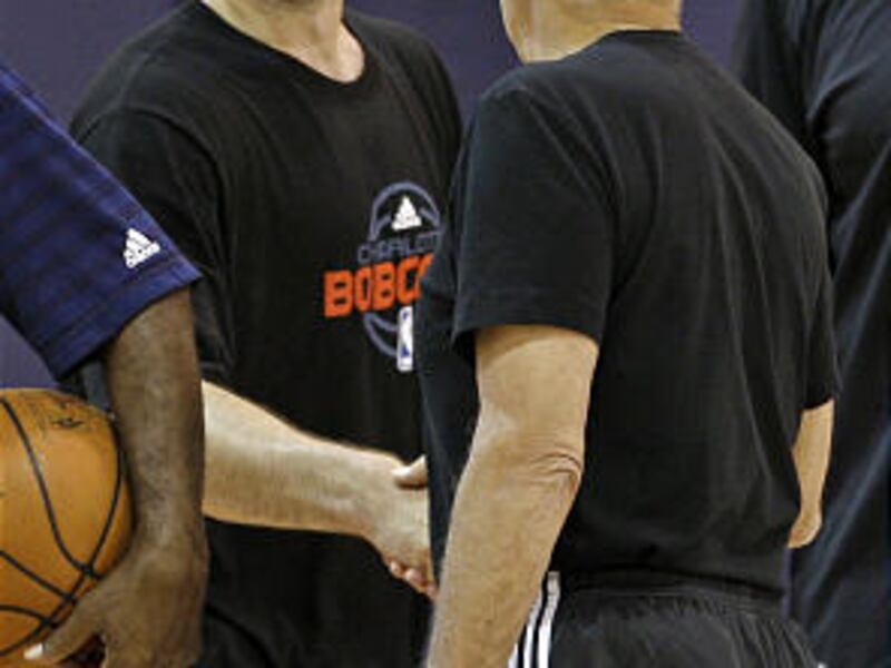 Former Davidson College guard Jason Richards, back, shakes hands with Charlotte Bobcats head coach Larry Brown, right, after pre-draft workouts for the team in Charlotte, N.C., Tuesday, June 24, 2008.
