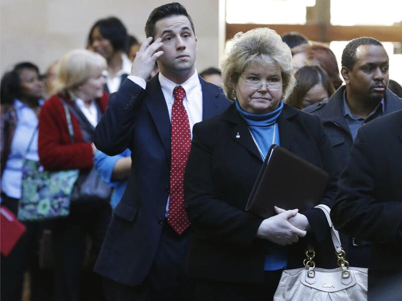 In this Wednesday, Jan. 22, 2014 photo, job seekers line up to meet prospective employers during a career fair at a hotel in Dallas.