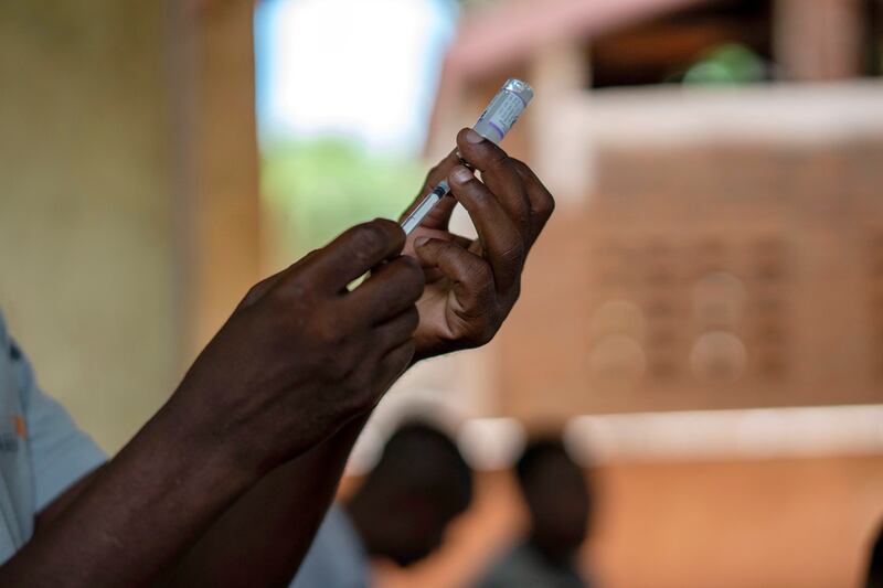 Health officials prepare to administer a vaccine in the Malawi village of Tomali.