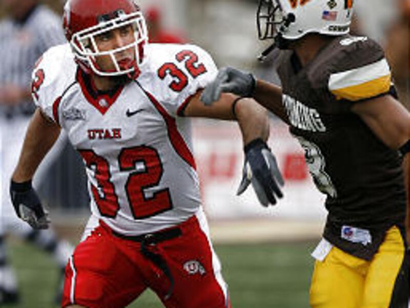 Former Utah star Eric Weddle, who was drafted by San Diego Saturday, smothers Wyoming receiver Michael Ford during a game last season.