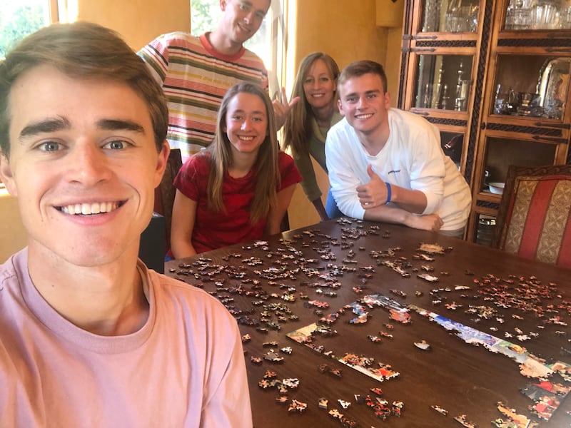 David Ball, left, and his family pose for a photo in their Palo Alto home. While stuck inside for the foreseeable future, David will decide whether to return for another year of tennis at BYU.