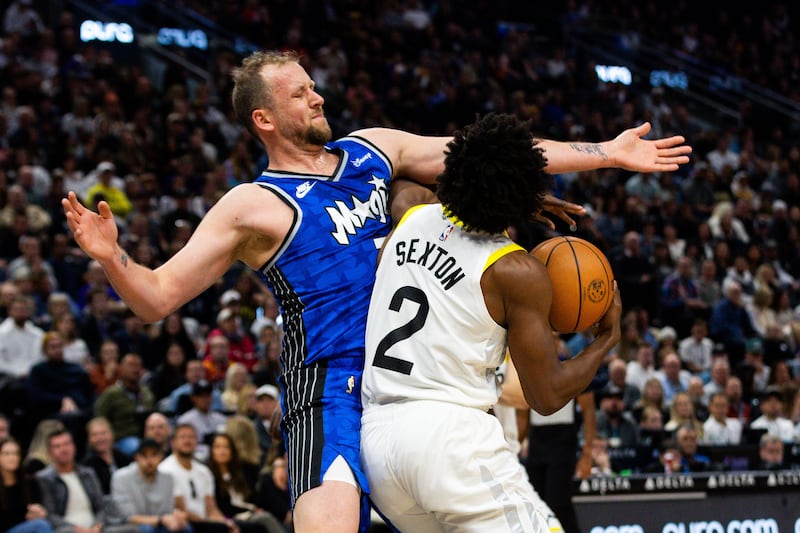 Utah Jazz guard Collin Sexton drives to the basket past Orlando Magic guard Joe Ingles during a game at the Delta Center.