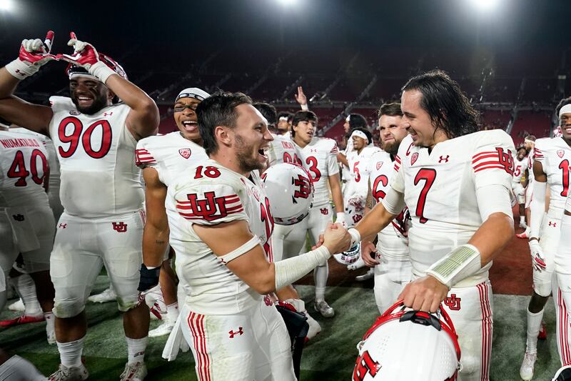 Utah quarterback Cameron Rising wide receiver Britain Covey shake hands