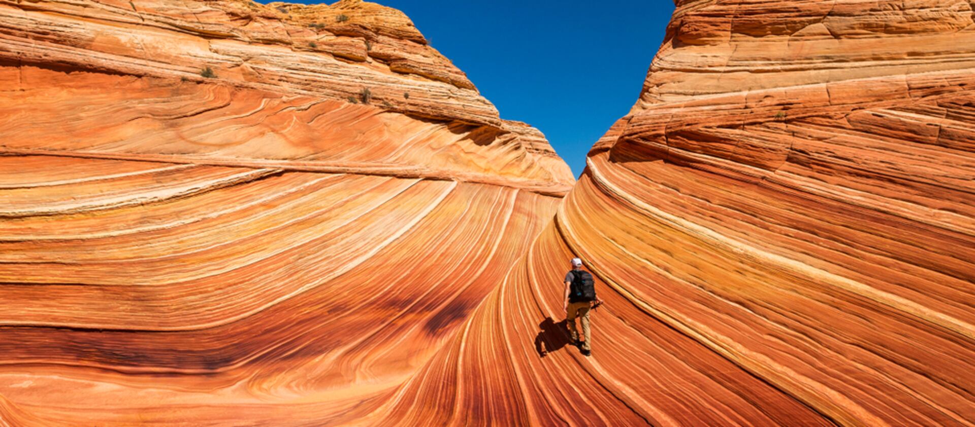 A person hikes the Wave in northern Arizona.