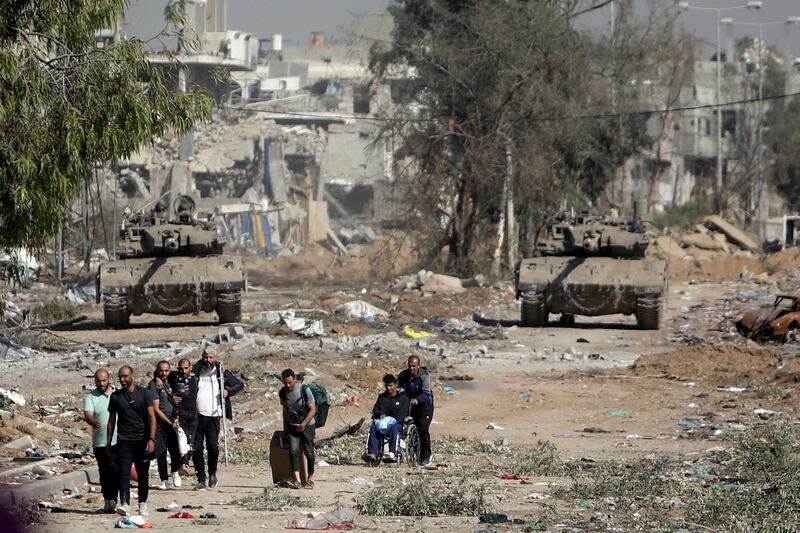 Palestinians flee to northern Gaza as Israeli tanks block the Salah al-Din road in the central Gaza Strip on Nov. 24, 2023, as the four-day cease-fire in the Israel-Hamas war began.