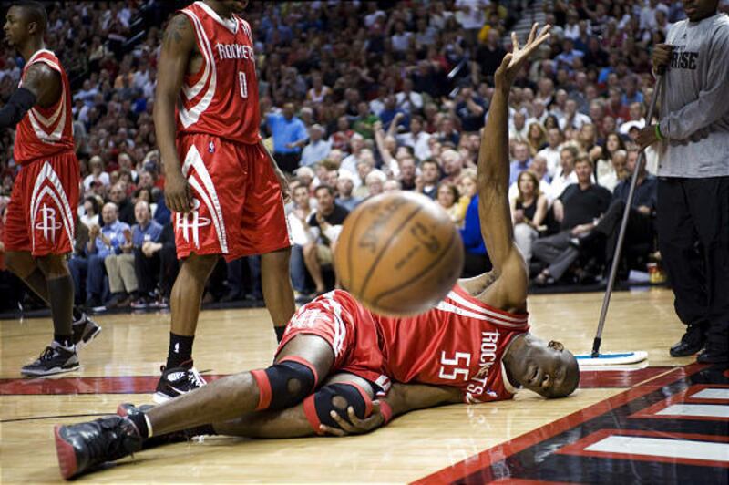 Houston Rockets' Dikembe Mutombo lies injured in the first half of an NBA basketball playoff game against the Portland Trail Blazers in Portland, Ore., on Tuesday.