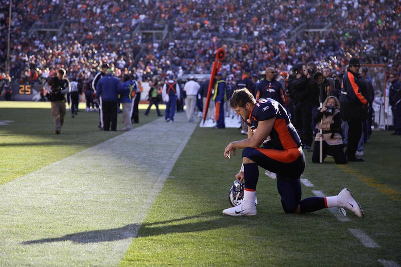 In this Dec. 11, 2011 file photo, Denver Broncos quarterback Tim Tebow prays in the end zone before the start of an NFL football game against the Chicago Bears, in Denver. Tebow recently trademarked the prayerful pose.