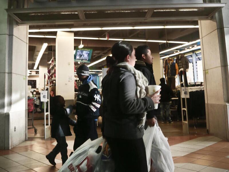 This Nov. 23, 2013 file photo shows shoppers approach Old Navy store at Atlantic Terminal Mall in New York. Getting up early on Black Friday for a little shopping? Doing your part on Small Business Saturday and Cyber Monday, too? It seems a lot of consum