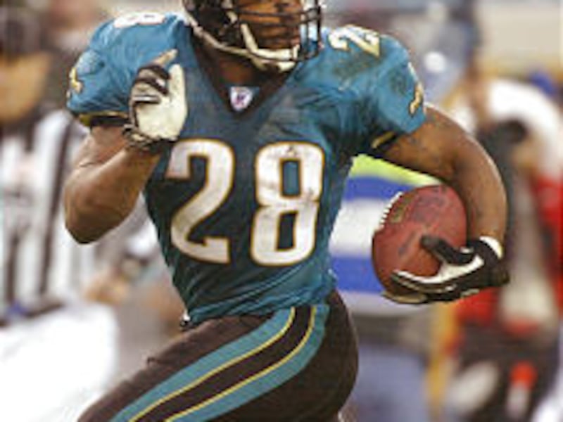 Fred Taylor looks back as he runs 32 yards for the game-winning TD Sunday. The last-minute score gave Jacksonville an upset victory.