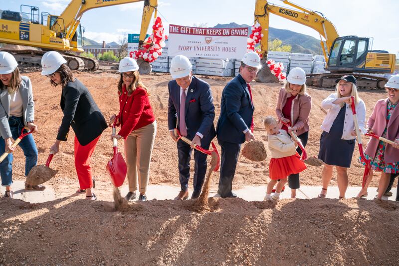 University of Utah President Taylor Randall, center, breaks ground for the Ivory University House with Clark and Christine Ivory.