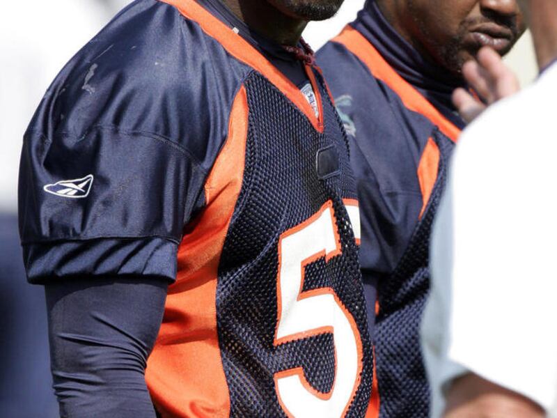 File - In this July 31, 2007, file photo, Denver Broncos linebacker D.J. Williams listens to defensive coach Jim Bates during NFL football training camp in Denver. A Denver judge declared a mistrial for Williams in a misdemeanor DUI case, Monday, May 21,
