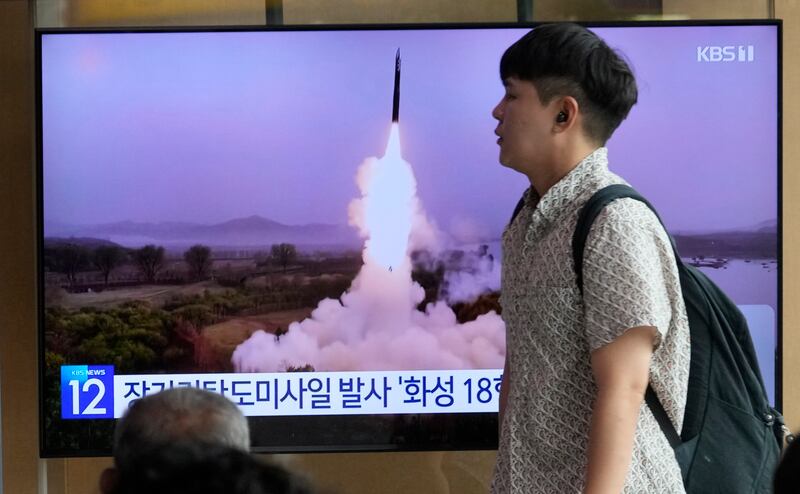 A TV screen shows a file image of North Korea’s missile launch during a news program at the Seoul Railway Station in Seoul, South Korea.