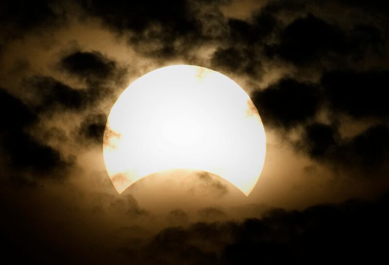 A partial solar eclipse is seen through clouds in Hyderabad, Pakistan on July 22, 2009.