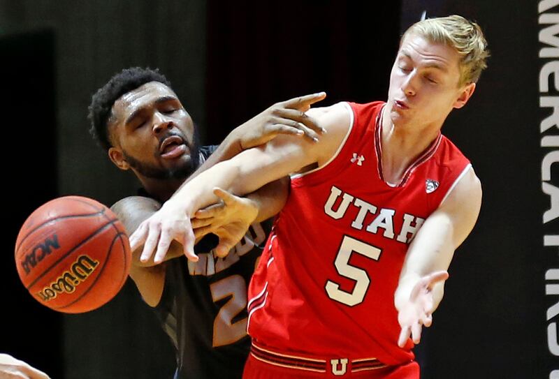 Missouri forward Kevin Puryear, left, and Utah guard Parker Van Dyke (5) battle for the ball in the second half during a game last November in Salt Lake City. Parker served an LDS mission in Alabama.