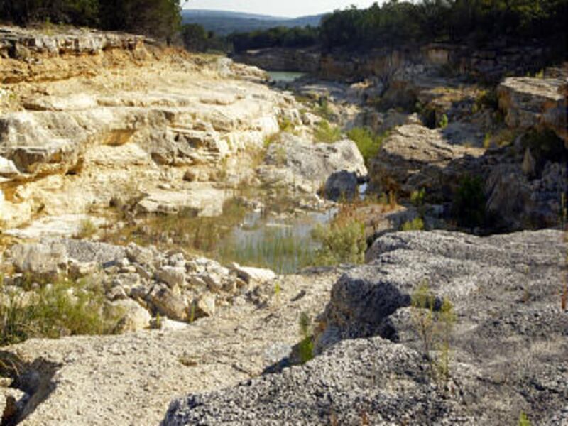 A gorge that is up to 80 feet deep was formed below the spillway of Canyon Lake in 2002 when a torrent of water overflowed the lake.